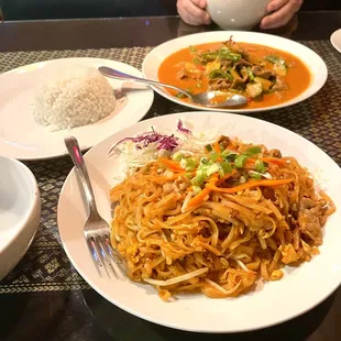 a plate of noodles and a bowl of soup