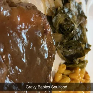 Cabbage/greens, smothered pork chops over rice, Mac&amp;cheese and yams over on the side.