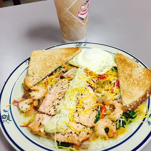 Dirty grits with shrimp and salmon and over easy eggs.