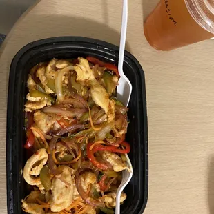 a bowl of food and a drink on a table