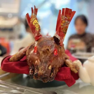 the head of a stuffed animal on a plate