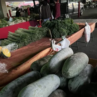 a display of cucumbers and other vegetables