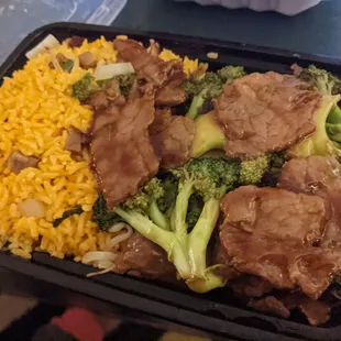 Beef and broccoli combo (pork egg roll not pictured). Meat was bland and served with yellow rice instead of fried white rice (weird).