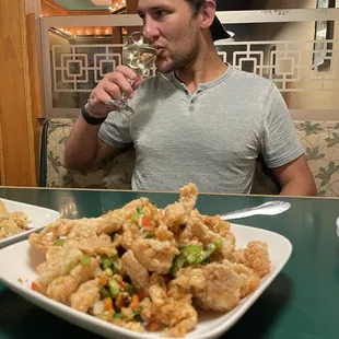 a man drinking a glass of wine