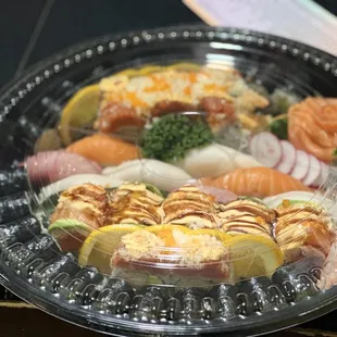 a plate of sushi and vegetables