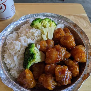 a plate of food with rice and broccoli