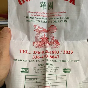 a person holding a bag of food