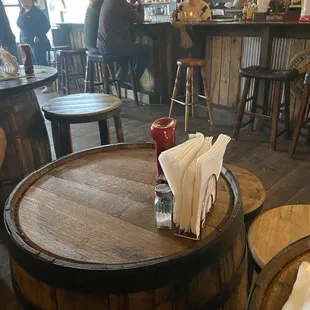 Barrels for tables, stools for seating.