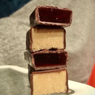 Cross sections of chocolate covered halvah and chocolate covered jellee.
