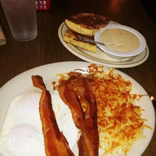 Bacon and eggs with grilled biscuits and gravy.
