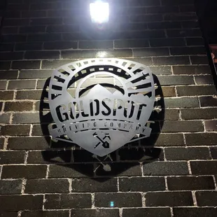 a sign on a brick wall