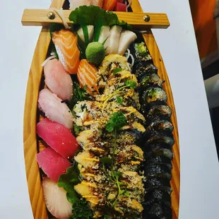 a wooden boat full of sushi