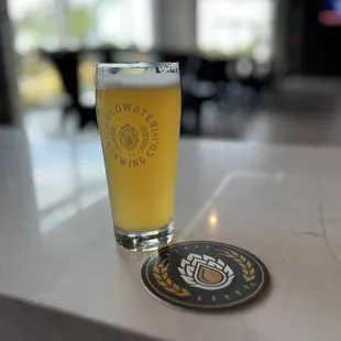 a pint of beer on a bar