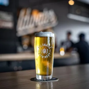 a pint of beer on a bar