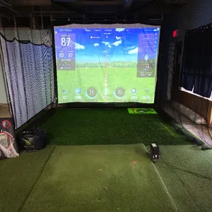 Indoor golf simulator is used for golf lessons