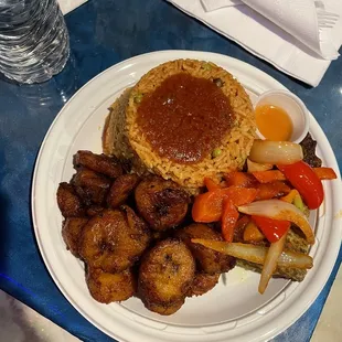 Fried 1/4 Grilled Tilapia with Jollof Rice and 14. Fried Ripe Plantains