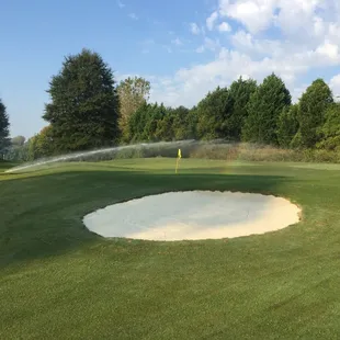 a water sprinkler on a golf course