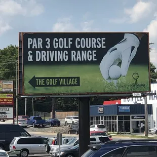 a golf course and driving range sign