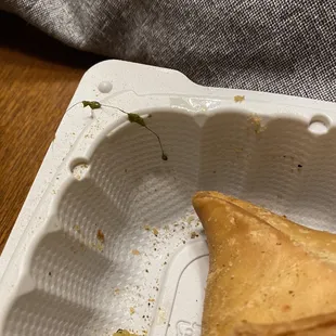 a piece of food in a styrofoam container