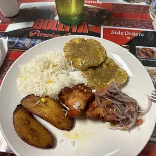 Pork, Plantain, rice, and same kind a bread like cake patties.