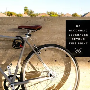 a bicycle leaning against a wall