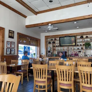 a woman sitting at a table in a restaurant
