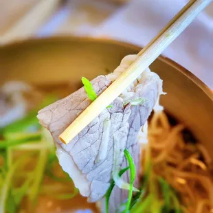 chopsticks in a bowl of ramen