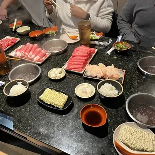 a group of people eating sushi