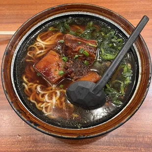 a bowl of ramen with meat and vegetables