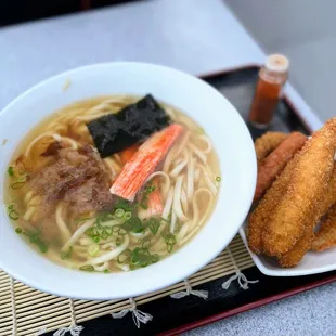 a bowl of ramen soup and fried shrimp