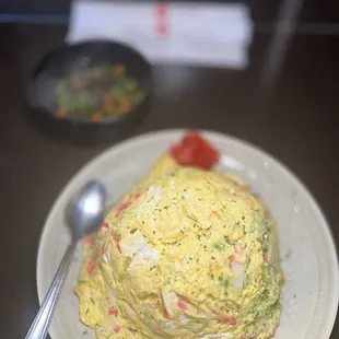 a stack of omelets on a plate with a spoon