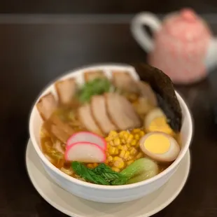 a bowl of ramen with meat and vegetables