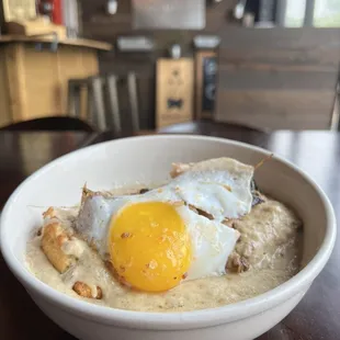 a bowl of oatmeal with an egg on top