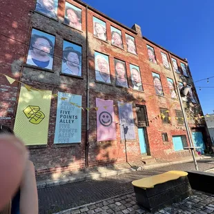 a woman standing in front of a brick building