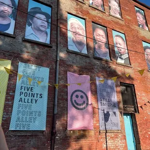 a brick building with posters on it