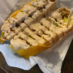 a hot dog covered in sauce