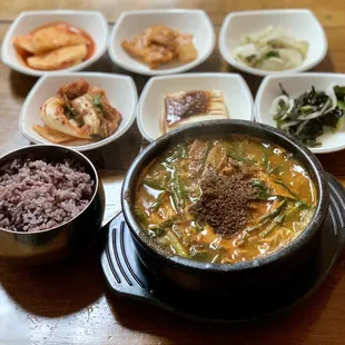 a bowl of soup and bowls of rice