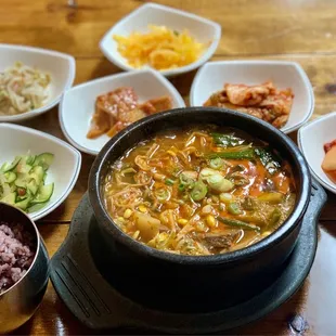 a bowl of soup and bowls of rice