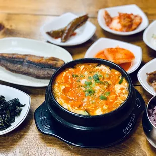 various dishes of food on a wooden table