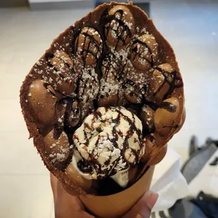 Chocolate Egg waffle with ice cream, fudge, and powdered sugar