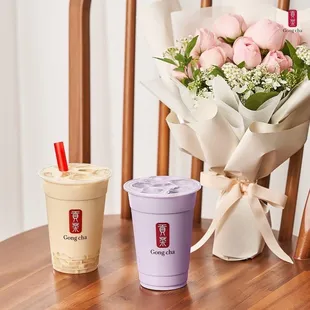 two cups of coffee and a bouquet of roses