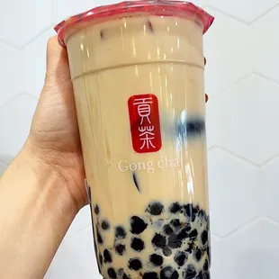 a hand holding a cup of bubble tea