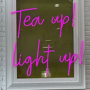 a neon sign that reads tea up light up