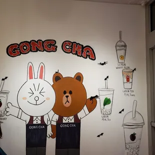 a mural of a bear and a cat