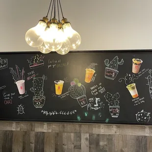 a chalkboard with various drinks on it