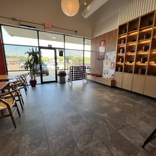 the inside of a restaurant with tables and chairs