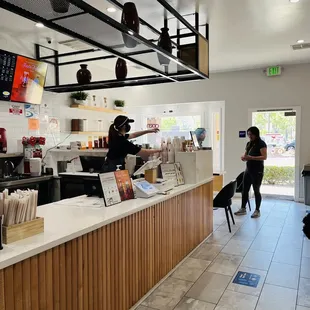 a woman and her dog in a coffee shop