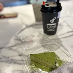a piece of matcha cake and a cup of coffee