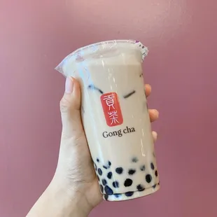 a hand holding a cup of bubble tea