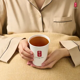 a woman holding a cup of tea